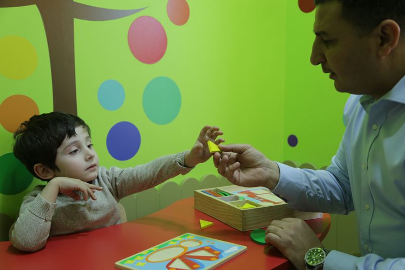 Therapist showing a child a picture card