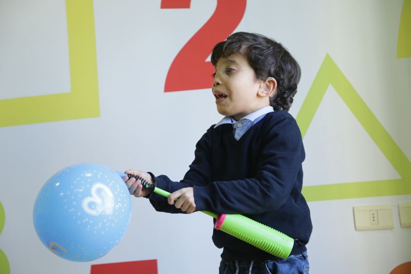Smiling girl playing with a balloon